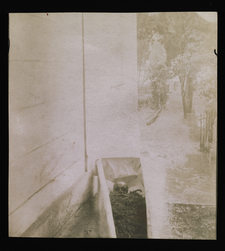 An image showing Smithson's open coffin next to the wall of the chapel. The coffin is open and the remains can be seen.