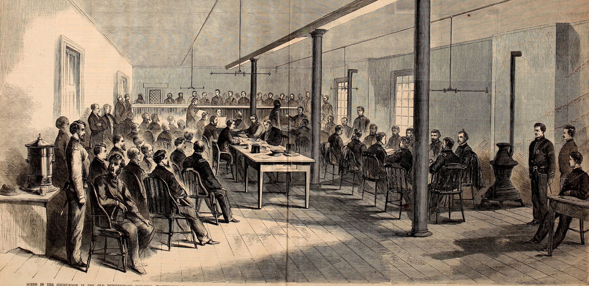 A sketch of the courtroom in the Old Arsenal Penitentiary where the trial of the Lincoln conspirators took place. The military commission is seated at a table to the right, the public watches on the left, and the prisoners sit lined up at the back of the room. Source: Ford's Theatre