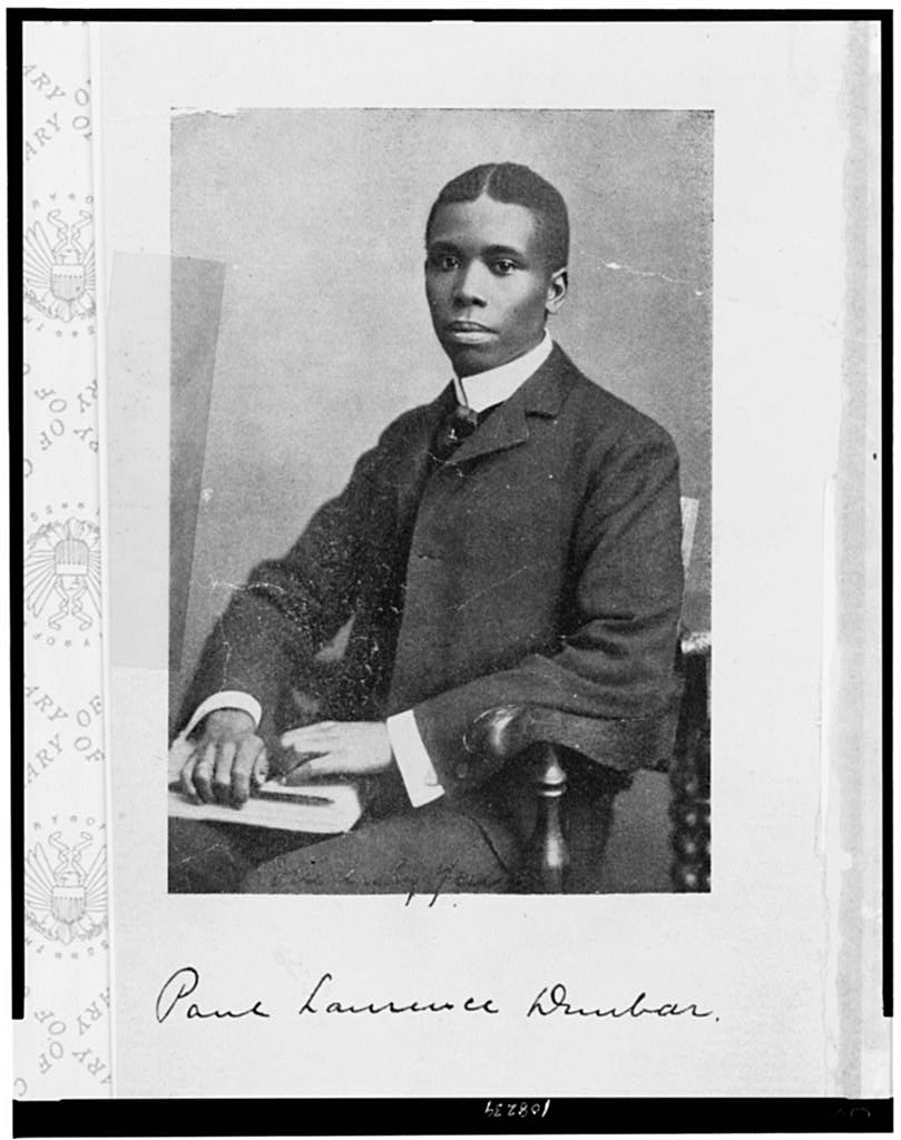 Waist up portrait of poet Paul Laurence Dunbar in 1905.