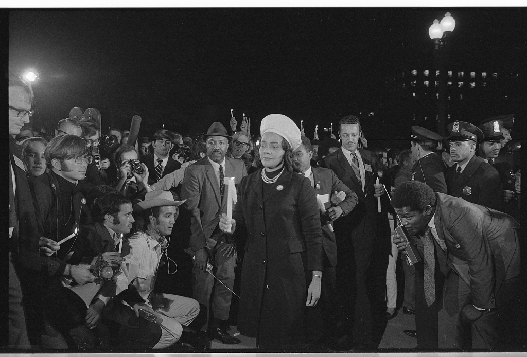 Coretta Scott King holding a candle and leading a march at night to the White House as part of the Moratorium to End the War in Vietnam