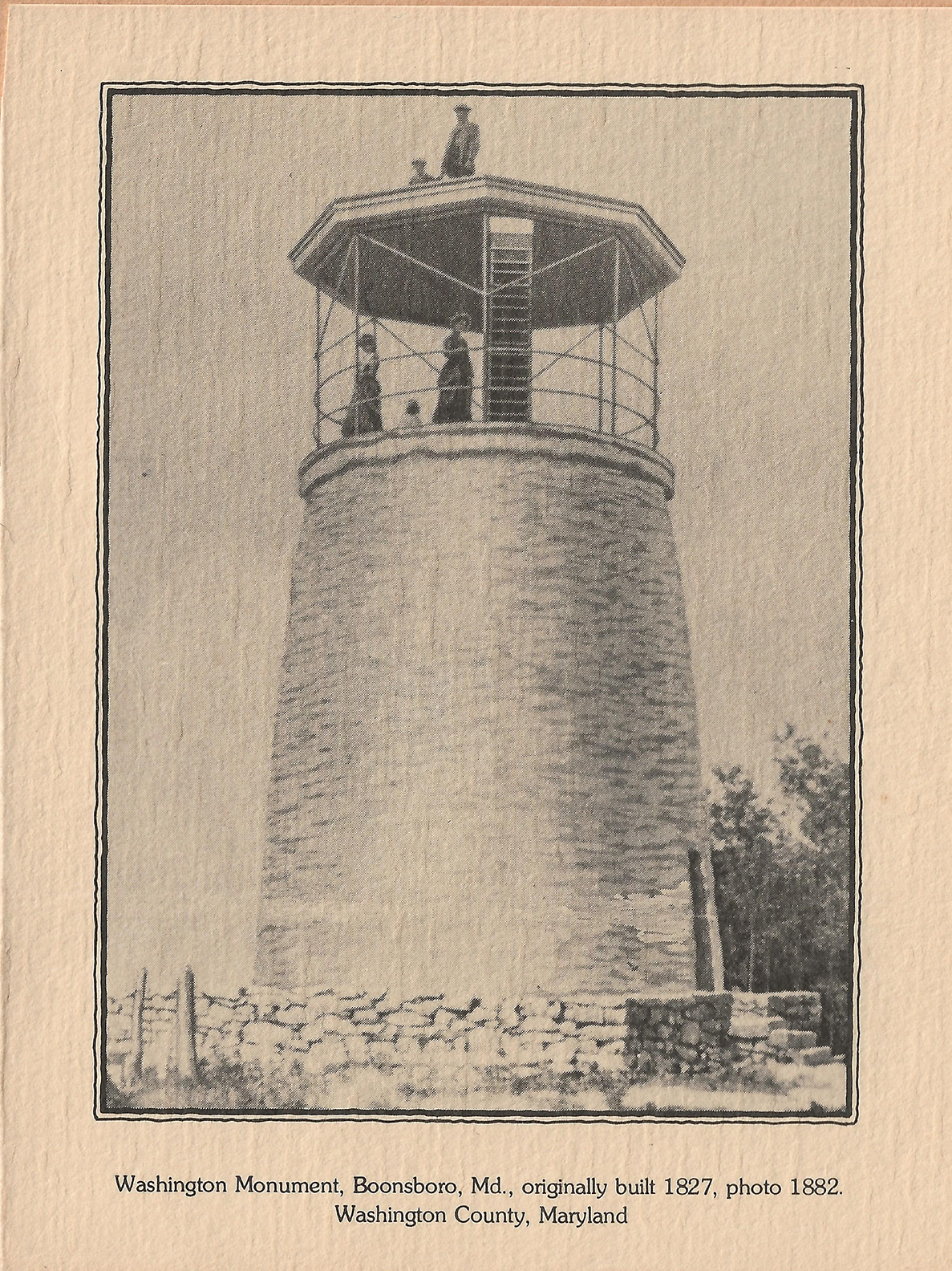 A stone tower with people on top