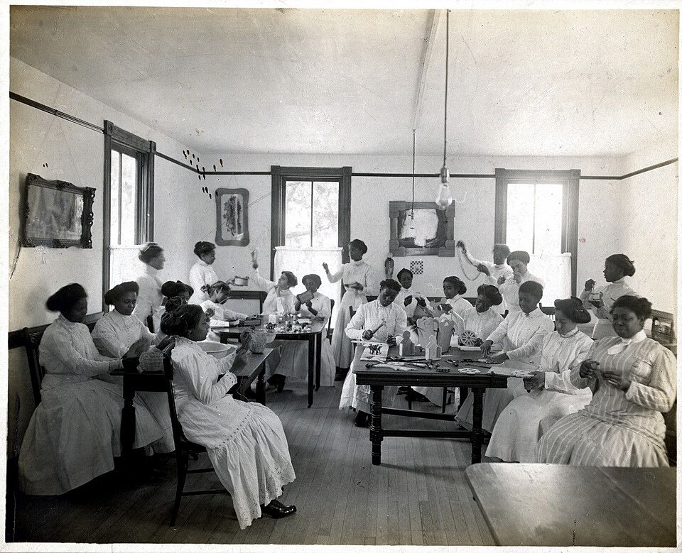 a vocational classroom with students doing various domestic tasks