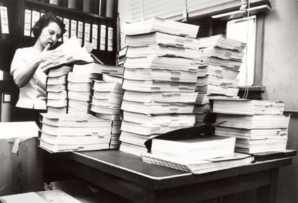 Chemist Lee Geismar, who was part of the team that reviewed the new drug application for thalidomide in the early 1960s, is shown some years later poring over several volumes of another application
