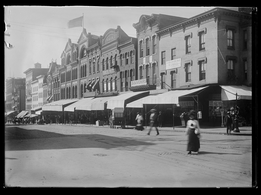 “View of various stores and shops on 7th Street, N.W., West side, looking South from E Street” (Photo Source: Library of Congress) View of various stores and shops on 7th Street, N.W., West side, looking South from E Street. Washington D.C, 1901. Photograph. https://www.loc.gov/item/2016646096/.