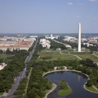 An aerial view of the National Mall showing the Washington Monument and the museums and other buildings in the distance