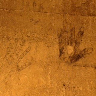 Two hand outlines drawn in charcoal, signed Joe and Mike