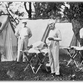 Henry Ford, Bishop William F. Anderson, Harvey Firestone (stooping). Thomas A. Edison and President Warren G. Harding pose as they shave in the morning