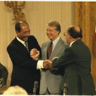 Anwar Sadat, Jimmy Carter and Menahem Begin shake hands after signing the Camp David Accords on September 17, 1978. (Source: National Archives)