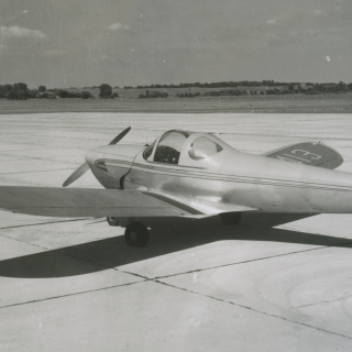 Small airplane sitting on runway.