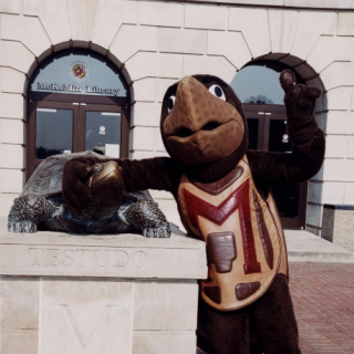 Testudo mascot standing with Testudo statue, McKeldin Library, University of Maryland, circa 2003