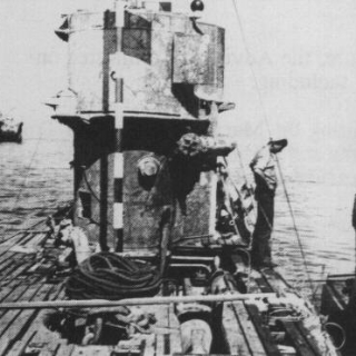 Black and white photo of Nazi U-Boat at surface after World War II.