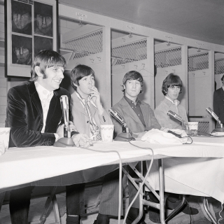 The Beatles hold a press conference in the Washington Senators locker room before their final D.C. concert on August 15, 1966 (Bettmann via Getty Images).