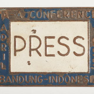 A copy of Ethel Payne's press pass for the Bandung Asian-African Conference. The pin is labeled "Press" and the conference title rings the label. 