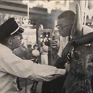 Officer Frank Collins confronts Laurence Henry on Glen Echo's Dentzel Carousel on June 30, 1960. (Photo source: National Park Service)