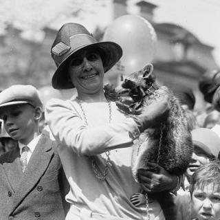 First Lady Grace Coolidge holds Rebecca the Raccoon
