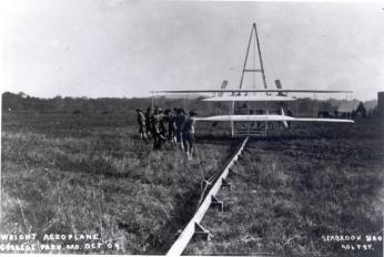 Soldiers help start the Wright Military Flyer (Wright Aeroplane) from the monorail at the College Park Airfield, October 1909. The plane is at the end of the catapult. Photo courtesy of the College Park Aviation Museum.