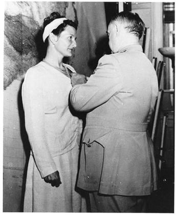 Virginia Hall receiving the Distinguished Service Cross (the second highest military honor given by the American government and the highest award a civilian can receive) by the head of the OSS, William Donovan.