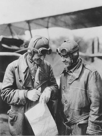 Major Reuben Fleet and Lieutenant George Boyle standing in front of the Jenny plane with a map.
