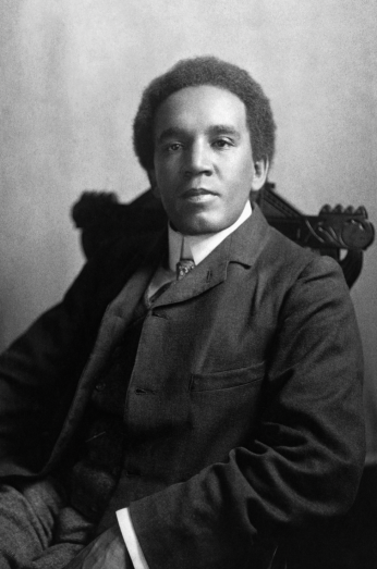 Portrait of Samuel Coleridge-Taylor, an Afro-Anglican man wearing a suit and sitting in a chair