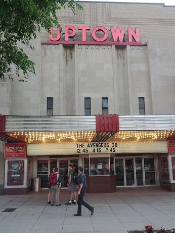 Street view of the Uptown Theater. Three people walk by a sign that advertises "The Avengers 3d." (Antonio Zugaldia from Washington, D.C., United States, CC BY 2.0 <https://creativecommons.org/licenses/by/2.0>, via Wikimedia Commons)