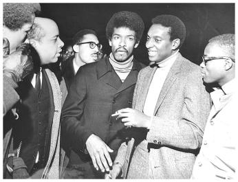 Stokely Carmichael, pictured smiling, meeting with students at Howard University.