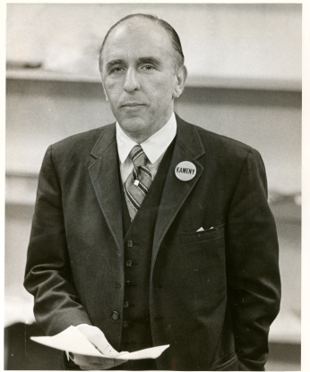 Frank Kameny wears a suit and smiles.