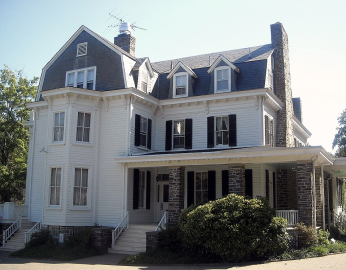 A photogrpah of a large three story historic mansion