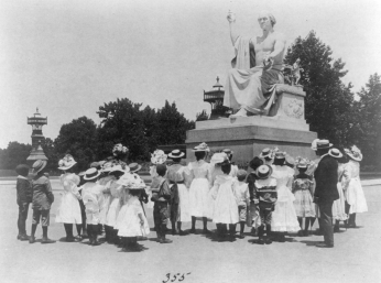 Group of African American school children look at Horatio Greenough statue of George Washington c. 1899