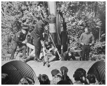 Demonstrators protesting Three Sisters Bridge construction "Demonstrators protesting construction of the Three Sisters Bridge are removed by police from atop huge culvert sections" October 1969