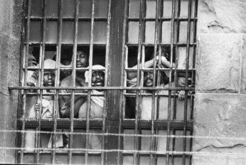 Inmates shouting through D.C. Jail window during the hostage standoff on October 11, 1972. (Photo Credit: Unknown, Courtesy DC Public Library, Star Collection, © Washington Post, All Rights Reserved.)