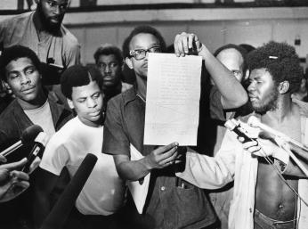 Inmates display letter signed by Kenneth Hardy promising no reprisals for the October 11, 1972 uprising at the D.C. Jail. (Photo Credit: Pete Schmick, Courtesy DC Public Library, Star Collection, © Washington Post, All Rights Reserved.)) Inmates display letter signed by Kenneth Hardy promising no reprisals for the October 11, 1972 uprising at the D.C. Jail. (Photo Credit: Pete Schmick, Reprinted with permission of the DC Public Library, Star Collection, © Washington Post.)