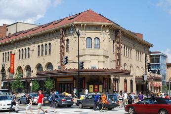 The revitalized Tivoli Theater after it opened in 2005. The revitalized Tivoli Theater in Columbia Heights, with tan walls and a red roof in an Italian architectural style. There is a large marquee, and signs with the word "Tivoli."
