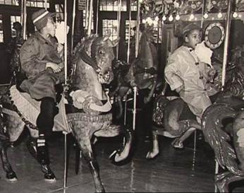 African American children enjoy cotton candy on the carousel after the desegregation of Glen Echo Park. (Photo source: National Park Service)