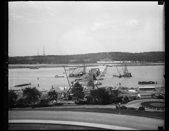 Construction on Arlington Memorial Bridge, to connect Washington with Arlington National Cemetery Image of a new bridge to connect Washington with Arlington National Cemetery, with the Arlington towers visible in the background to the left.