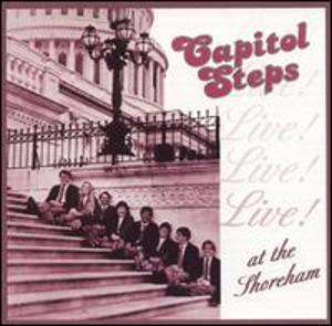 Album Cover with people sitting on the Steps of the Capitol. The title of the album is "The Capitol Steps-Live! at the Shoreham"