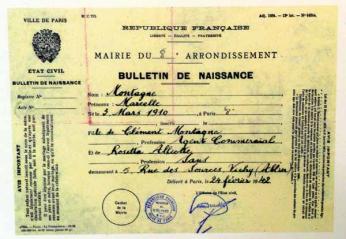 A French identification card for Marcelle Montagne, one of Virginia Hall’s long list of aliases. The card has black cursive writing on a faded yellow background. 