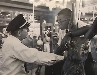 Officer Frank Collins confronts Laurence Henry on Glen Echo's Dentzel Carousel on June 30, 1960. (Photo source: National Park Service)