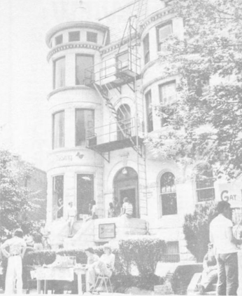 Exterior of Lambda Rising Bookstore with a booth in front of it for Gay Pride day, 1975