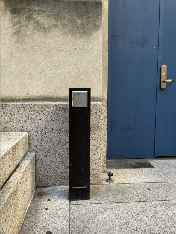 A blue door with a "push to open" sign next to it