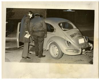 Police inspect Volkswagon beetle, which four inmates used as a getaway vehicle after they escaped from Lorton on Christmas night in 1974. (Photo Credit: Geoffrey Gilbert, Reprinted with permission of the DC Public Library, Star Collection, © Washington Post.)