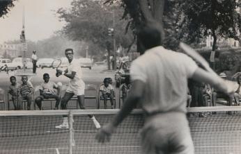 Arthur Ashe and Charlie Pasarell playing tennis in the street. Arthur Ashe and Charlie Pasarell playing tennis in the street.