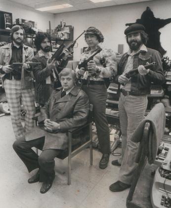 Lt. Robert Arscott and the Operation Sting team sit amid stolen goods
