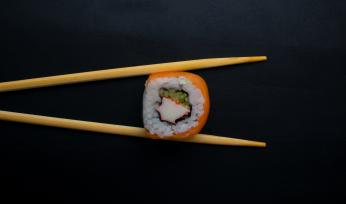 Chopsticks holding sushi roll. (Credit: Mahmoud Fawzy on Unsplash) Chopsticks holding sushi roll. (Credit: Mahmoud Fawzy on Unsplash)