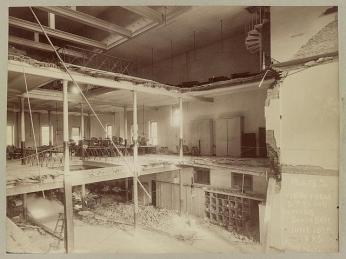 A black-and-white photo of the interior of Fords Theatre in 1893. All three stories are visible with the floors/ceilings roughly cut away.