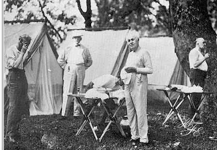 Henry Ford, Bishop William F. Anderson, Harvey Firestone (stooping). Thomas A. Edison and President Warren G. Harding pose as they shave in the morning