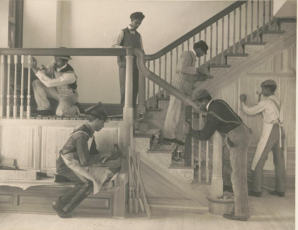 A group of Hampton Students constructing a staircase on a house.