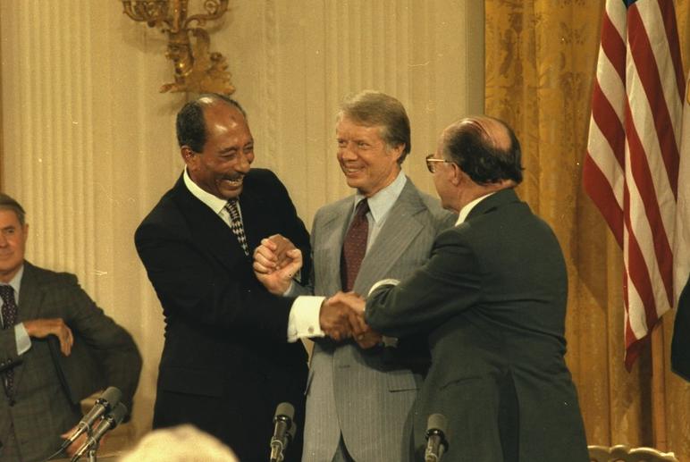 Anwar Sadat, Jimmy Carter and Menahem Begin shake hands after signing the Camp David Accords on September 17, 1978. (Source: National Archives)
