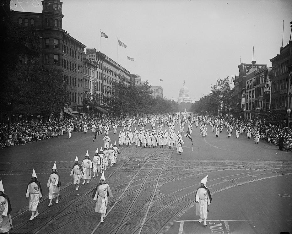 Ku Klux Klan members marching down Pennsylvania Ave in Washington, DC in 1926. (Source: Library of Congress)