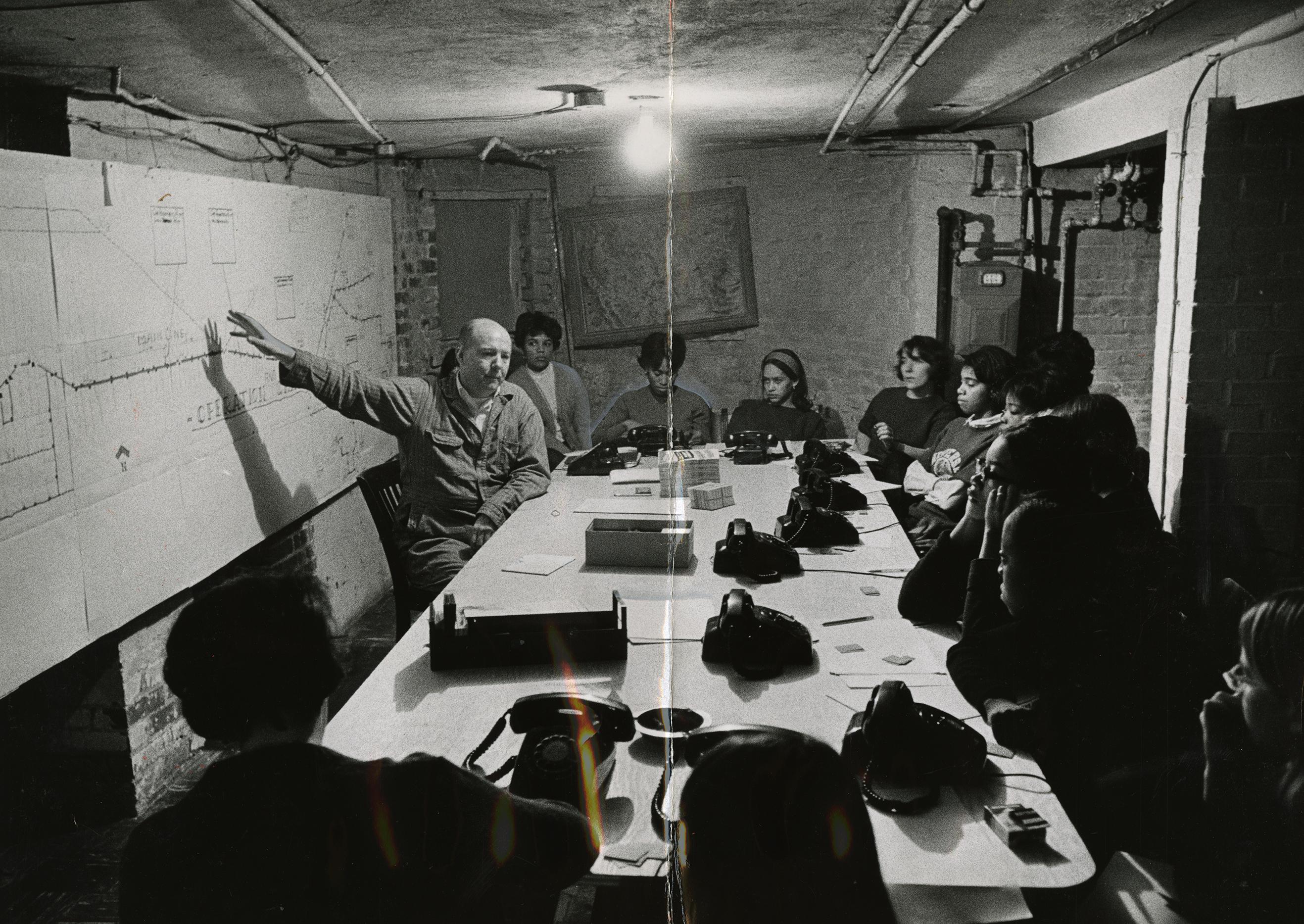 L.D. Pratt and SNCC volunteers sit at table and look at bus route map as they discuss the boycott. (Reprinted with permission of the DC Public Library, Star Collection, © Washington Post.)