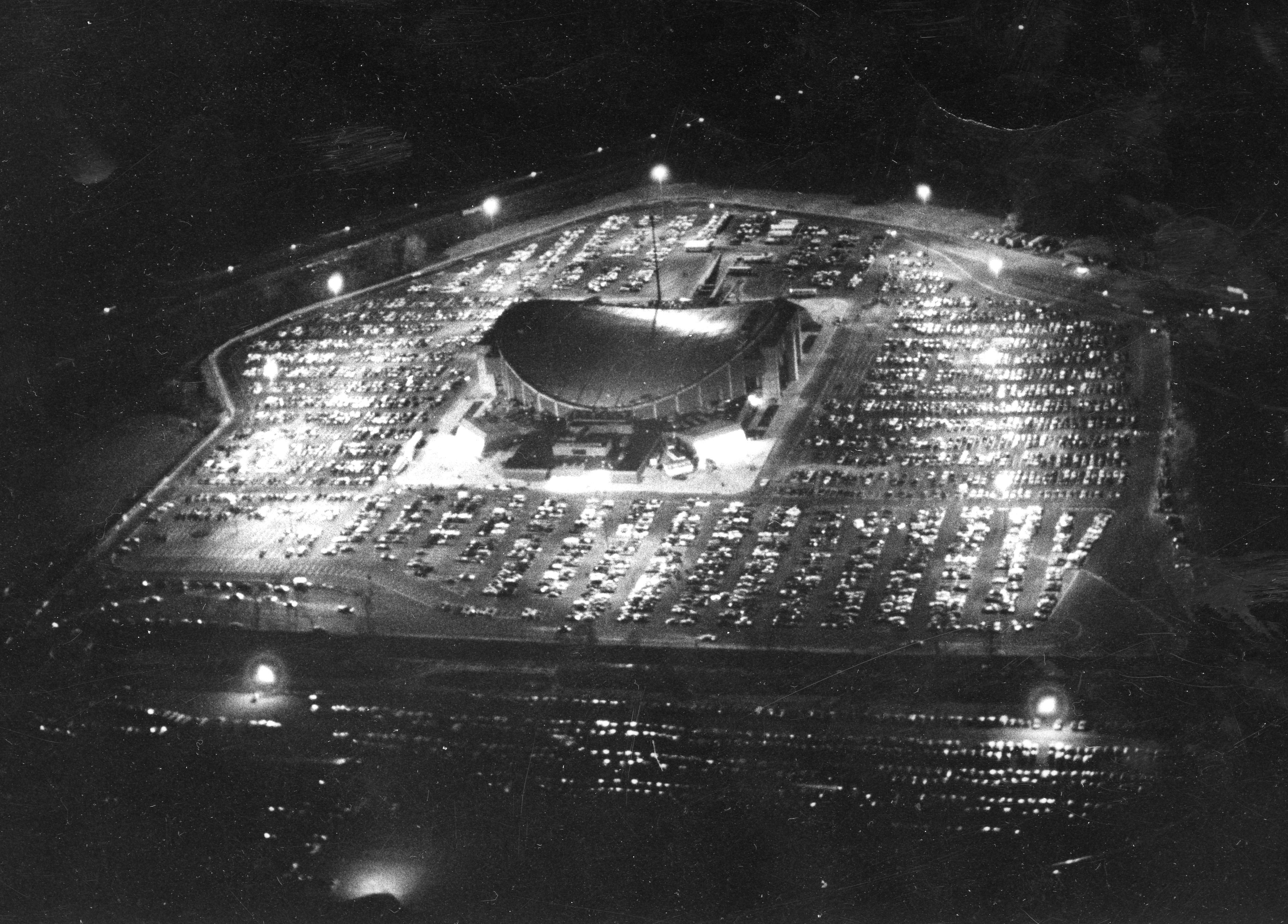 Nightime aerial photograph of Capital Center arena surrounded by parking lots.